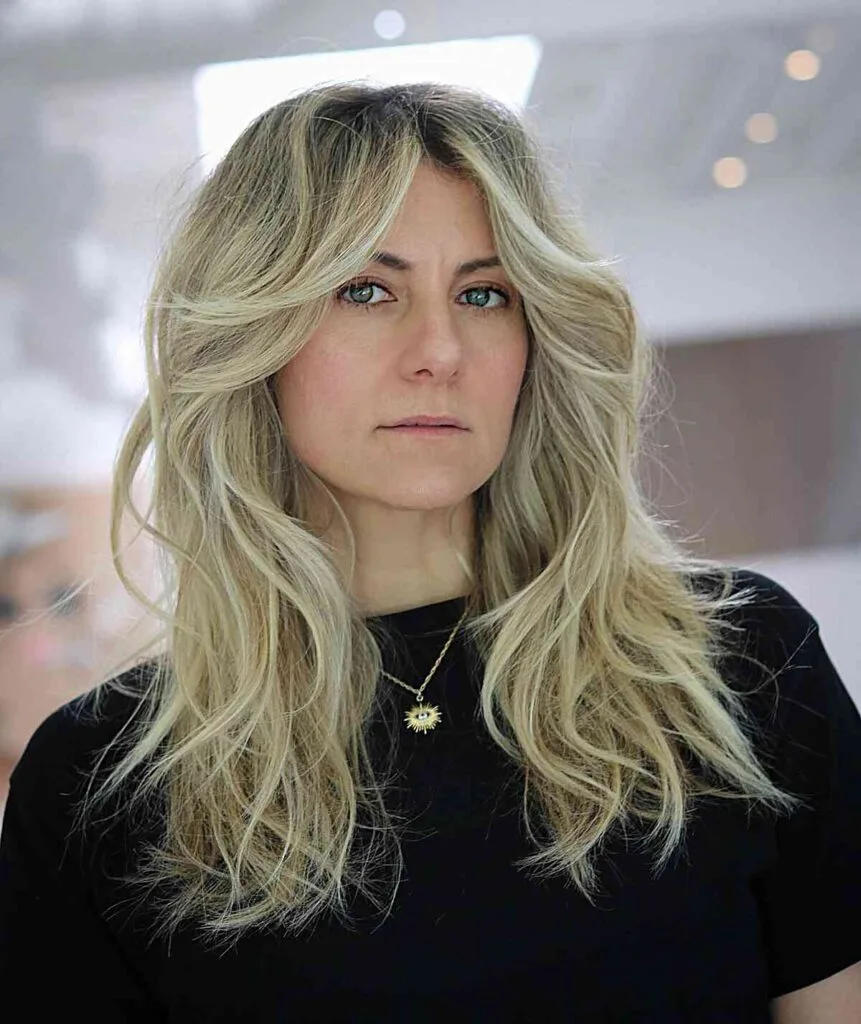 Stylish Face-Framing Tousled Blonde Shag for Women Over 40 with Mid-Long Hair