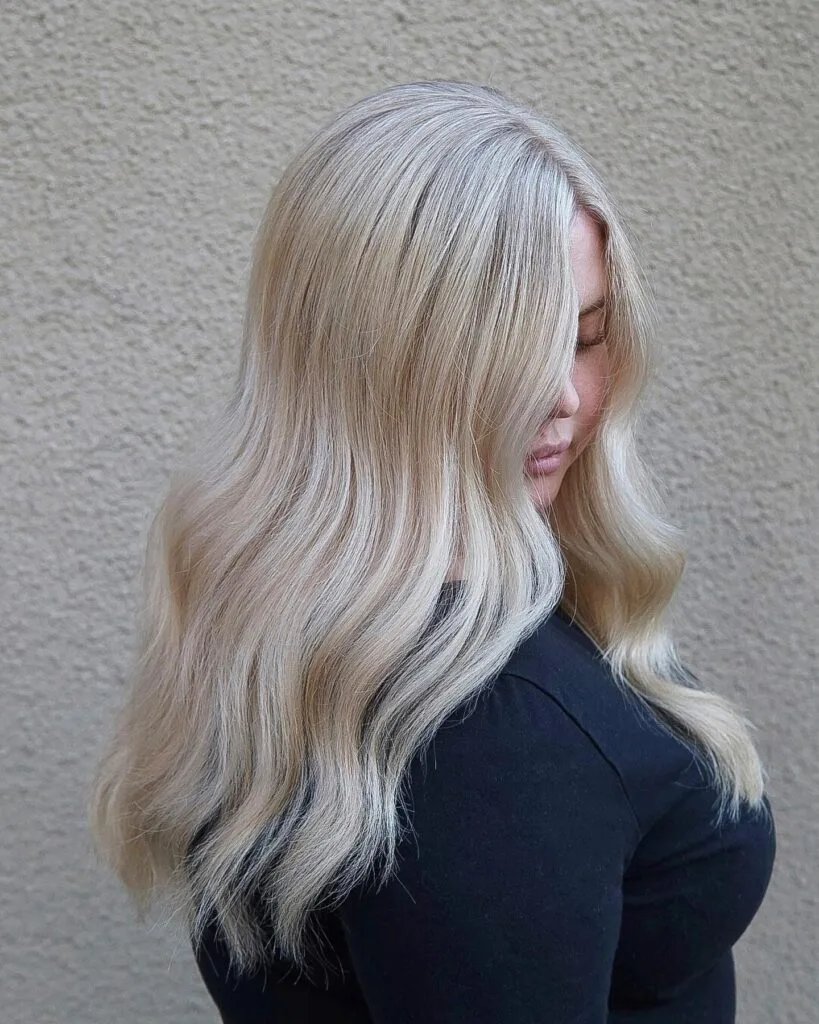 Stylish Light Blonde Waves with Subtle Root Shadow