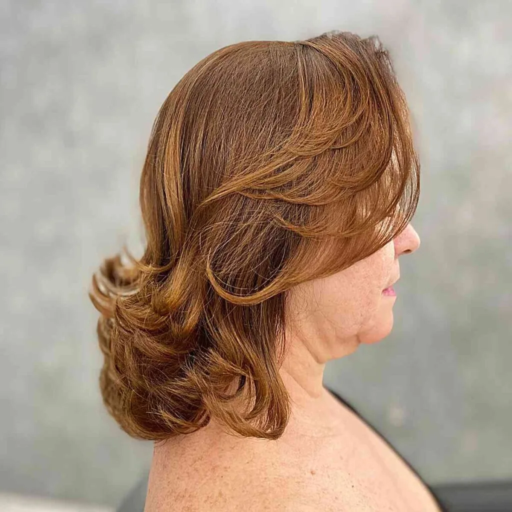Textured Bangs and Uplifted Ends for Ladies Over Fifty with Shoulder-Length Hair