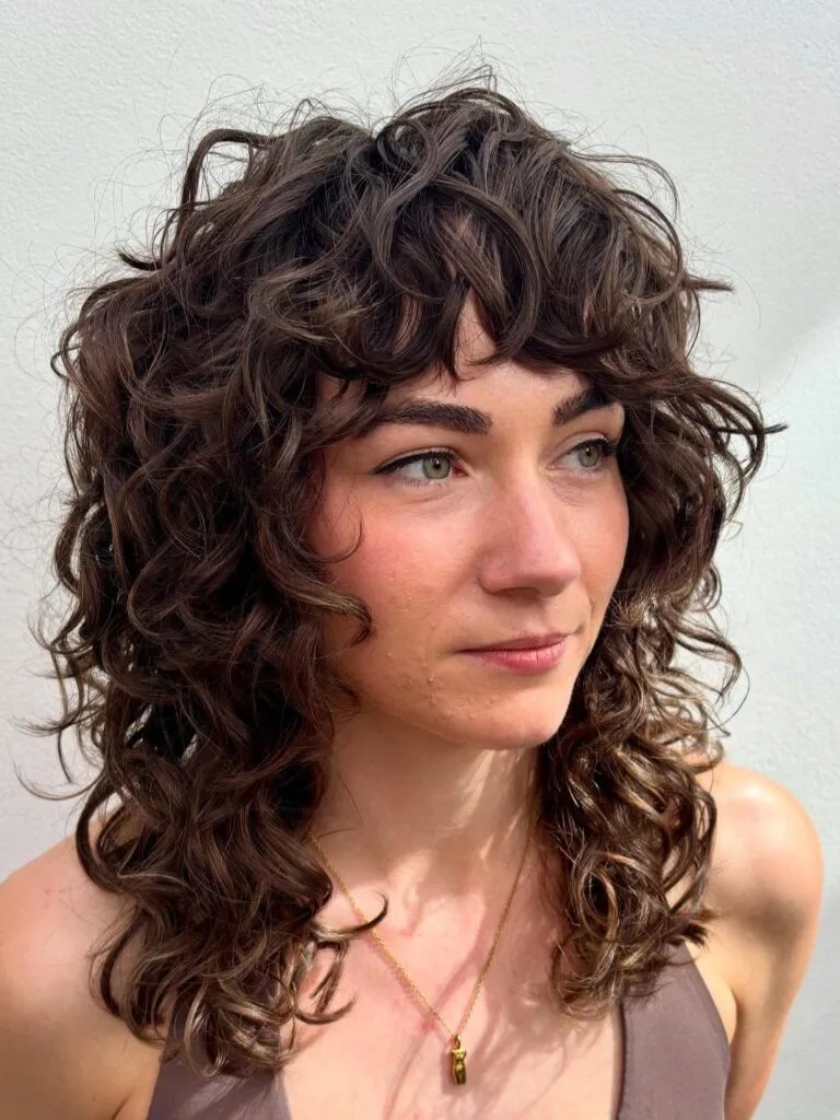 Textured Curly Shoulder-Length Cut with Soft Bangs