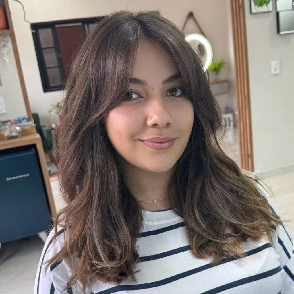 Textured Long Layers with Soft Curtain Bangs