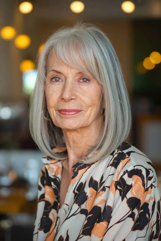 Asymmetrical bob with side-swept bangs, offering a youthful and sophisticated touch