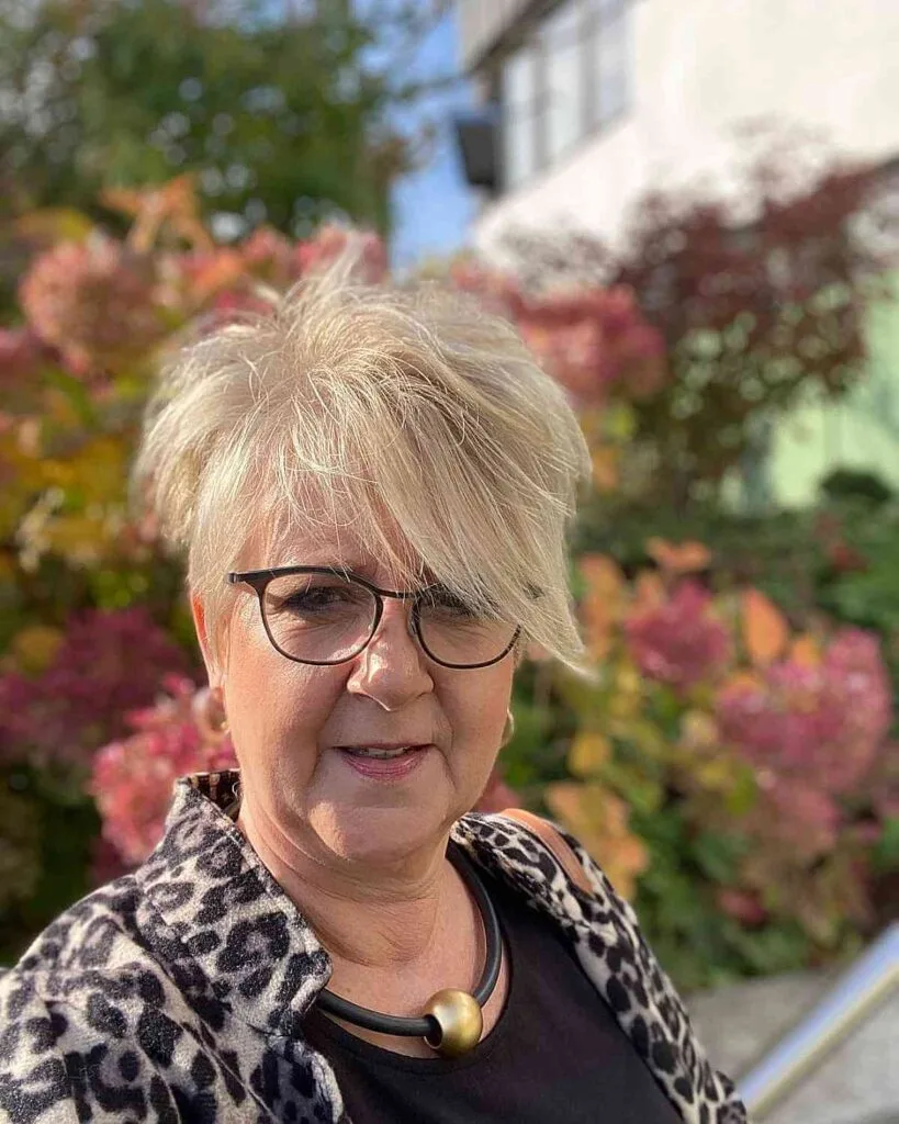 Chic Blonde Pixie with Extended Bangs for 60-Year-Olds with Glasses