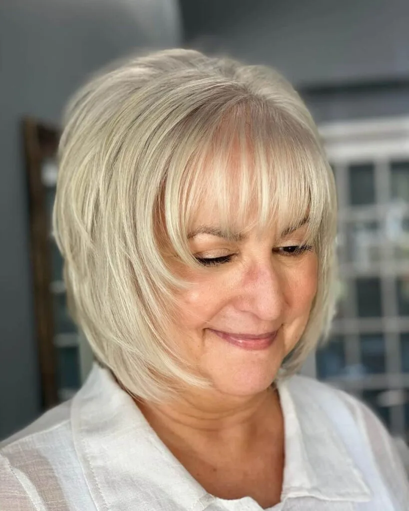 chic silver shaggy bob with bangs for fine haird ladies over 50