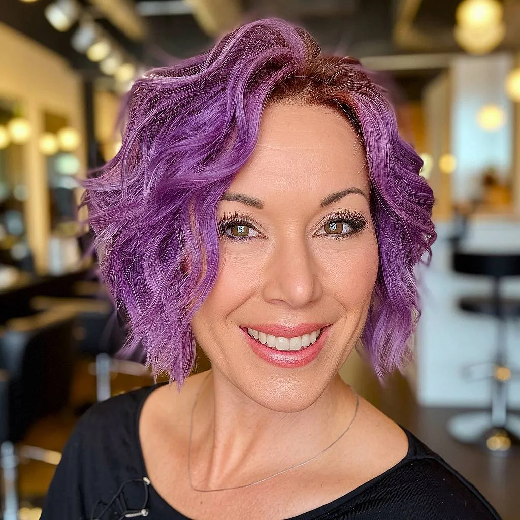 Edgy layered shag bob with bold purple color and textured waves
