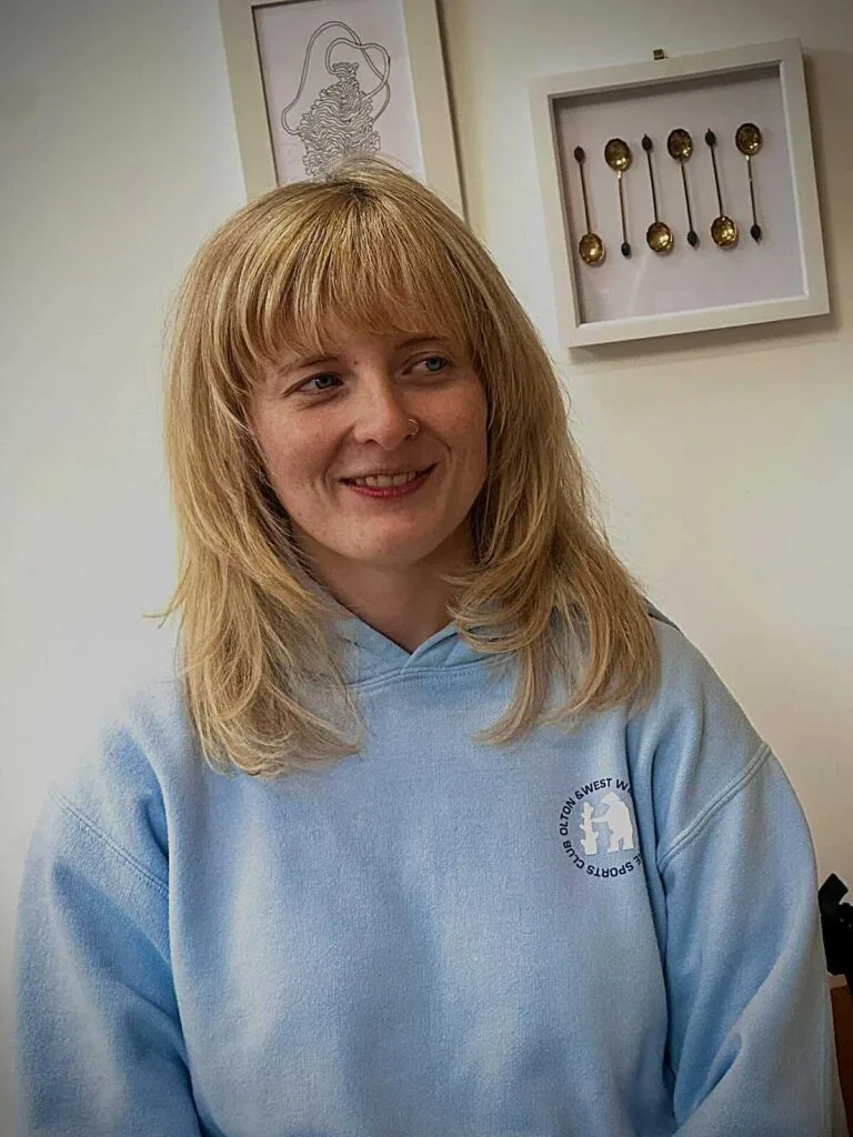 Honey blonde shoulder-length shag with full bangs