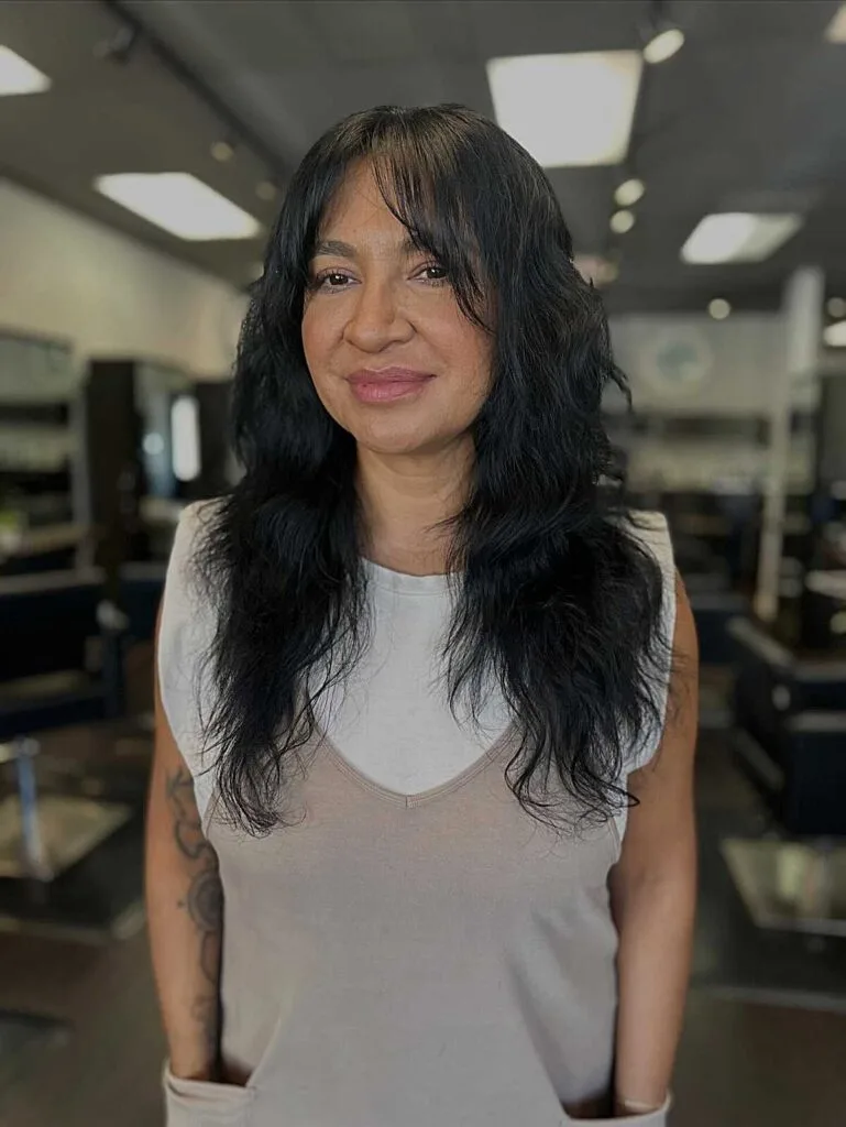Long black wavy shag with soft face-framing bangs