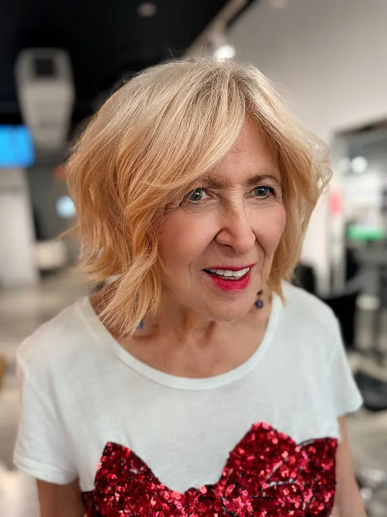 Peach blonde tousled shaggy bob on older woman
