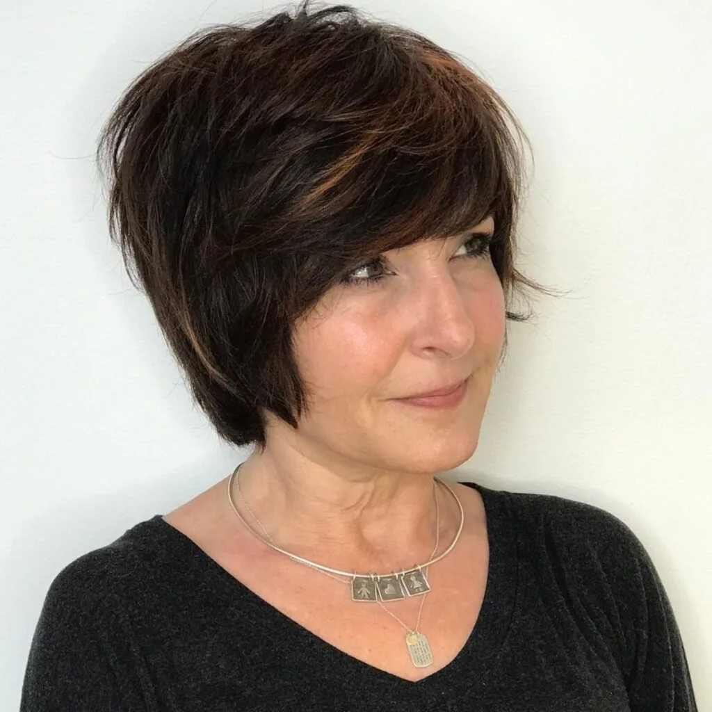 Stylish long pixie with feathered layers for women over 50 with thick hair