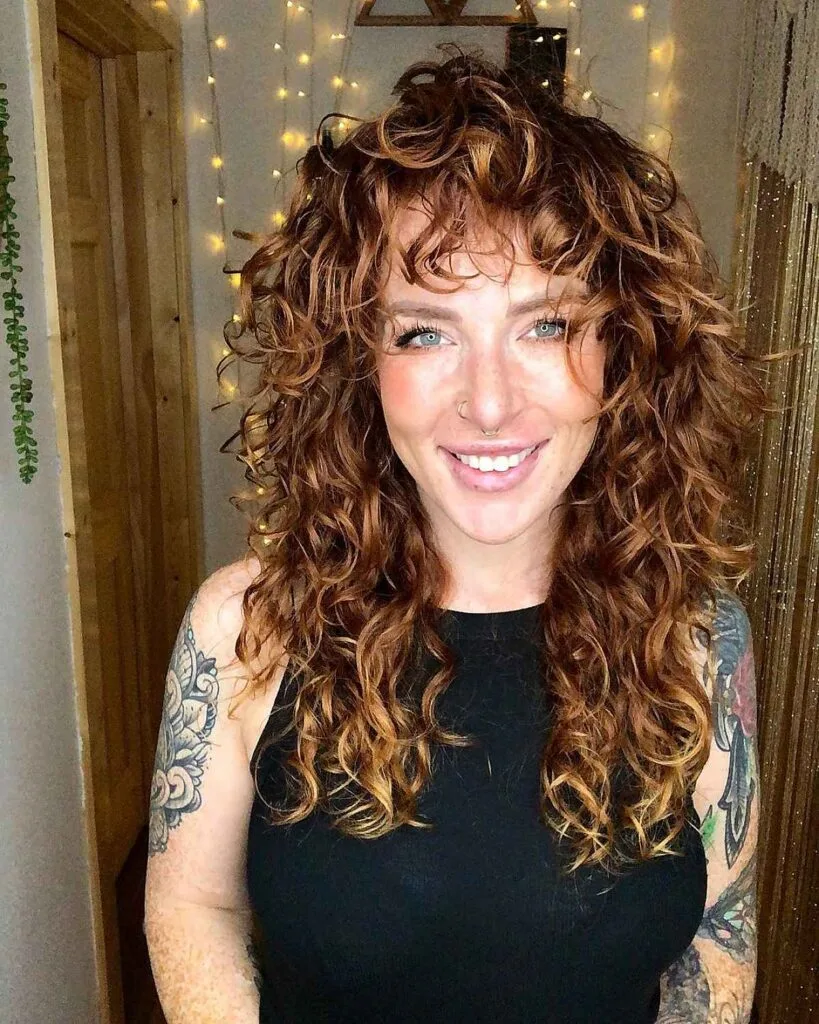 Voluminous Shoulder-Length Curls with Highlights for Women Aged 40