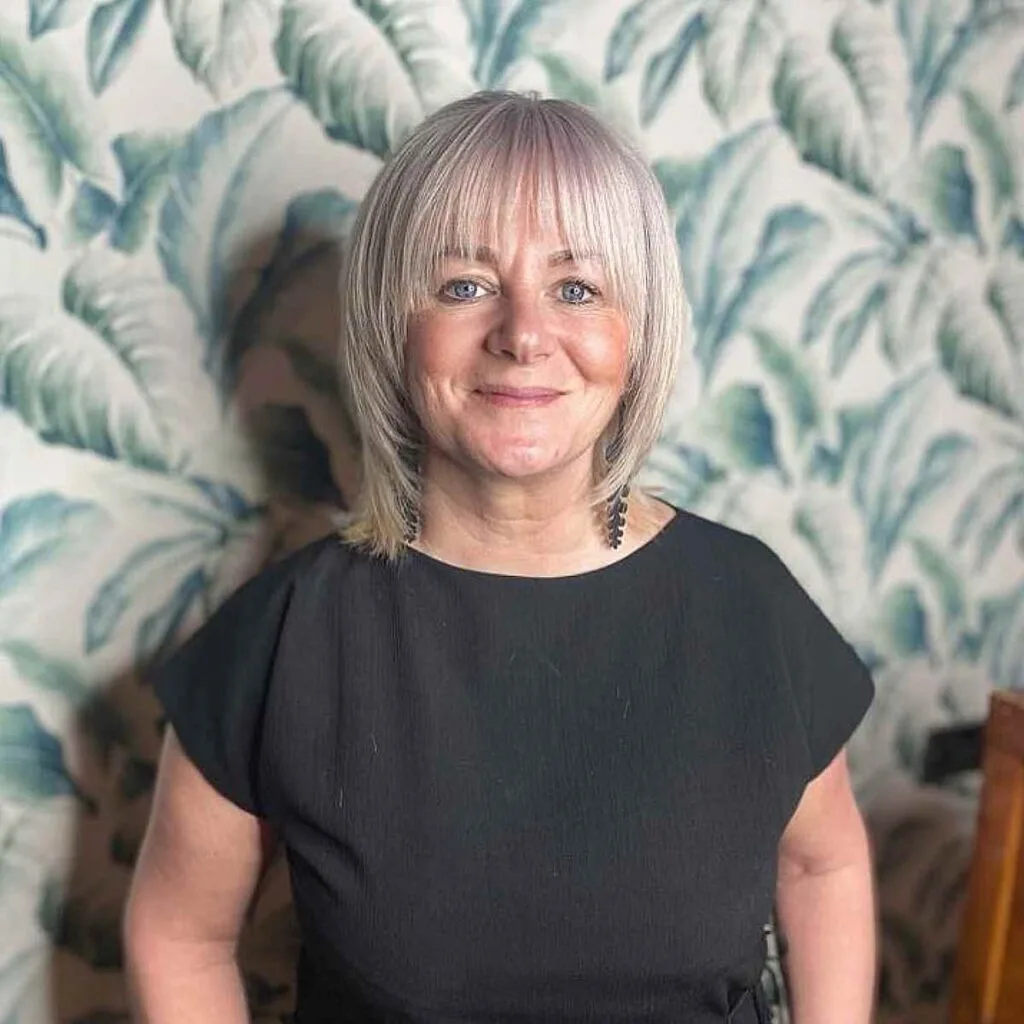 Ash Blonde Lob with Face-Framing Layers and Bangs for Mature Women