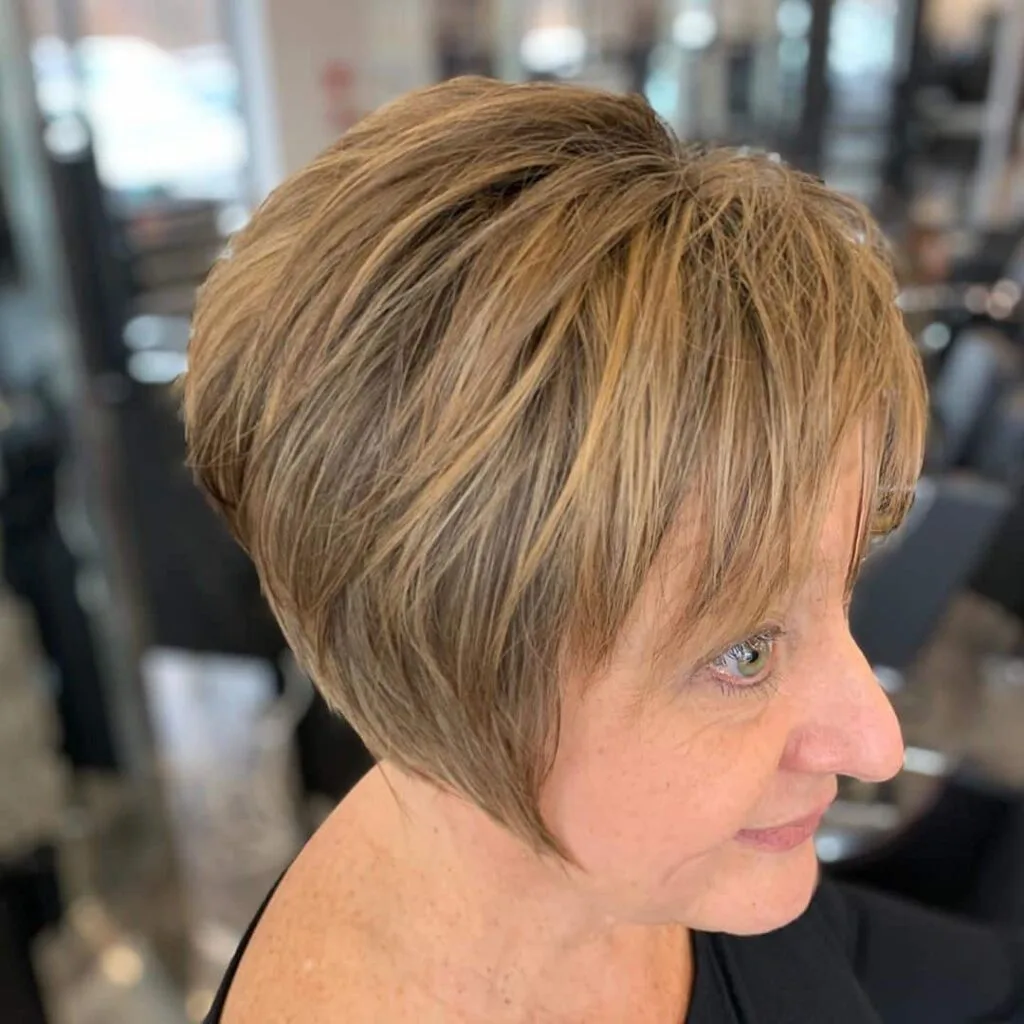 chic long pixie featuring choppy bangs on 50 year old woman