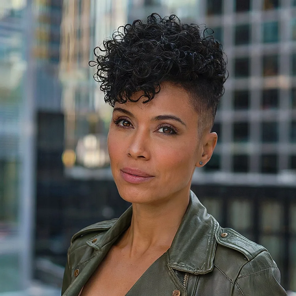 Curly pixie shag with shaved sides for women over 40, combining volume and edgy contrast