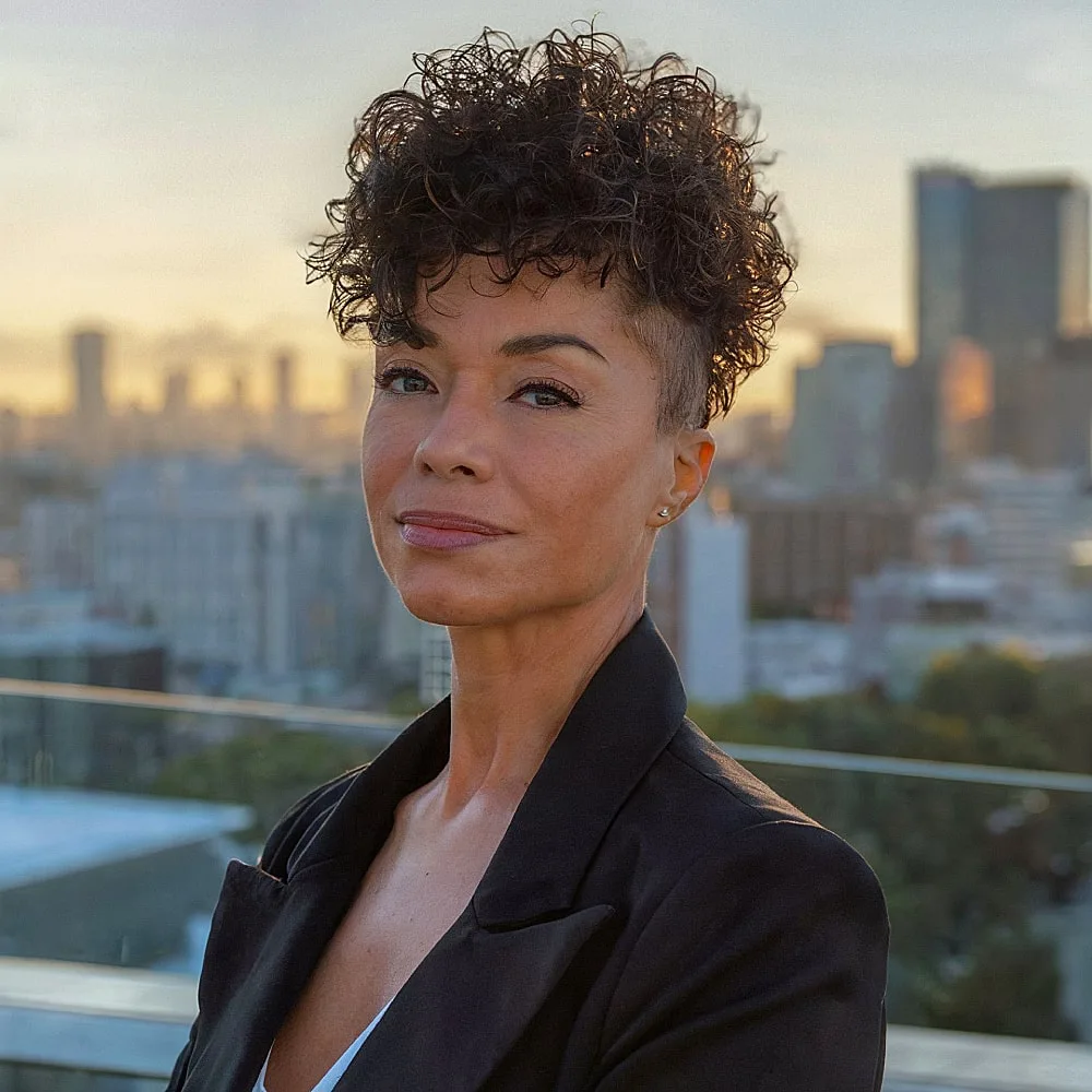 Edgy pixie shag with curly top and shaved undercut for women over 40 who want bold texture