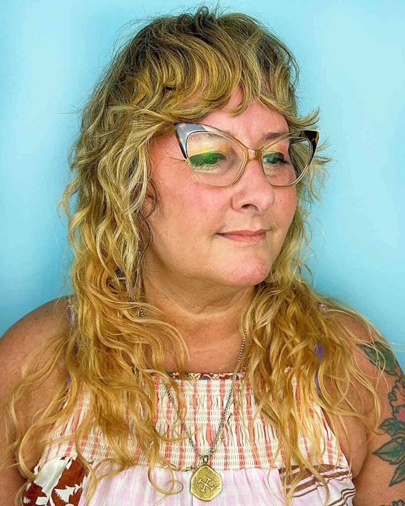 Long Blonde Shag with Loose Curls and Bangs for Women over 40