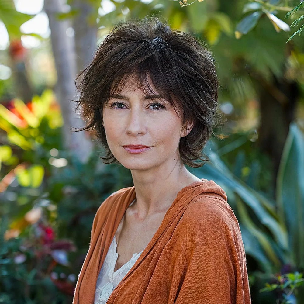 Longer pixie shag haircut with feathered ends and wispy fringe for mature women wanting softness