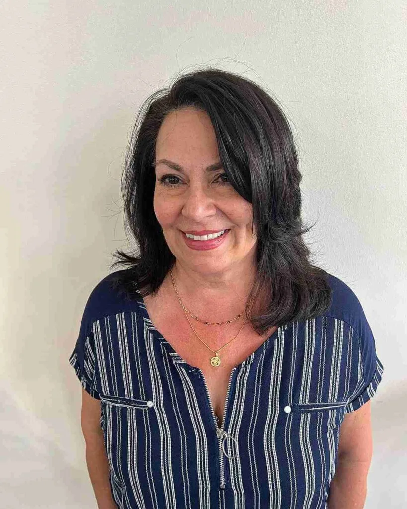 Medium Layered Hairstyle with Side Part for Women 50 and Over
