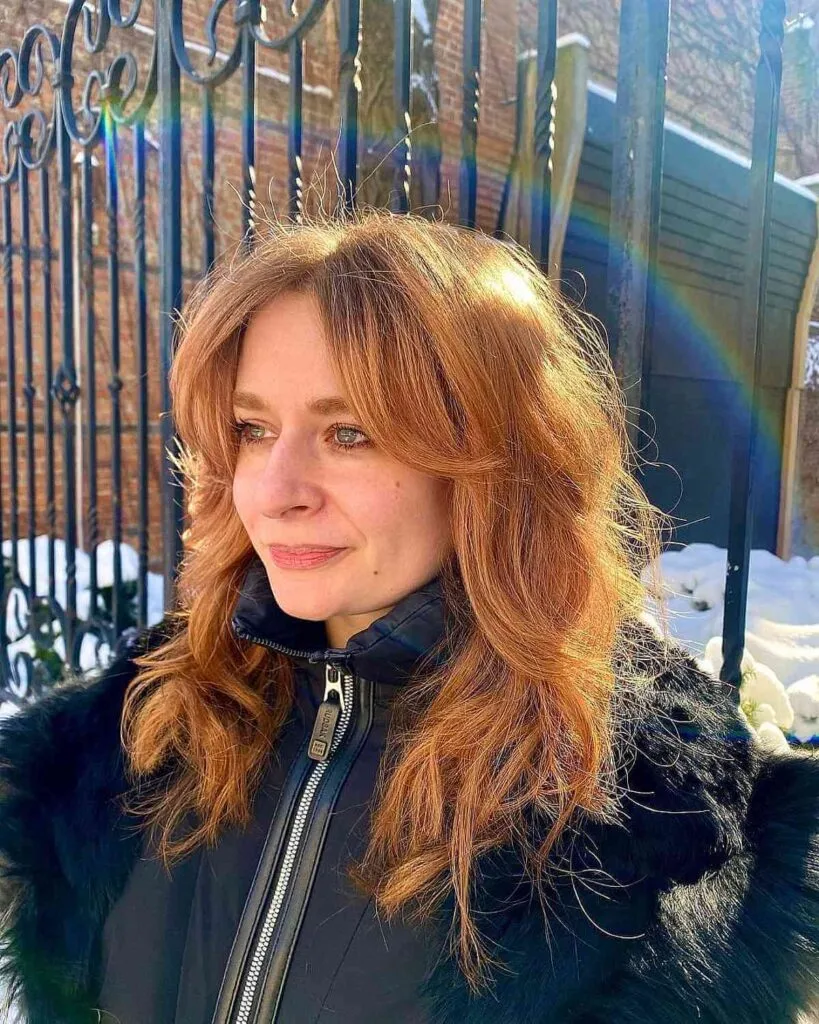 Medium Shag with Curtain Bangs for a 40-Year-Old with Thick Hair