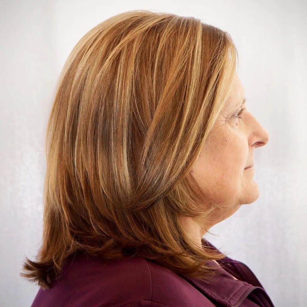 medium short layered hairstyle for women in their 50s with round face