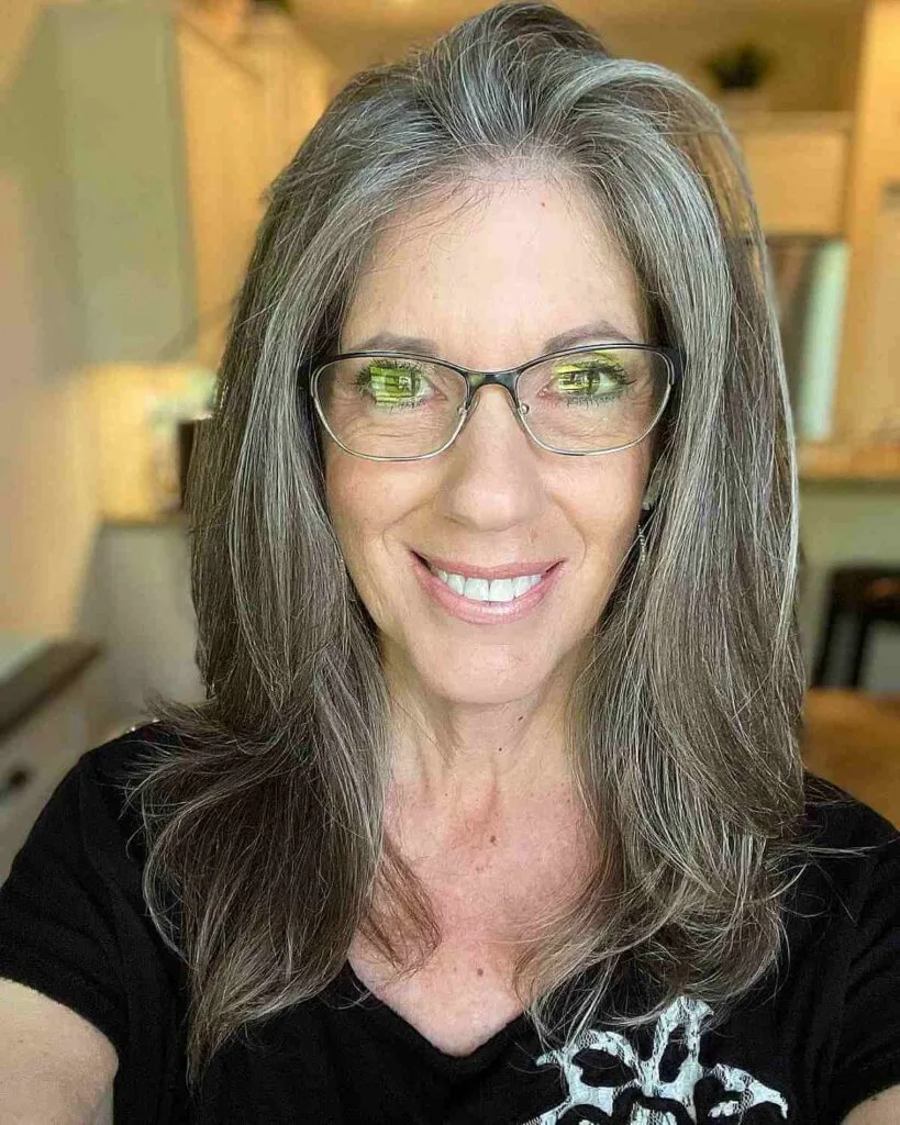 Mid-Length Layered Hairstyle on Grey-Haired Women Over Fifty