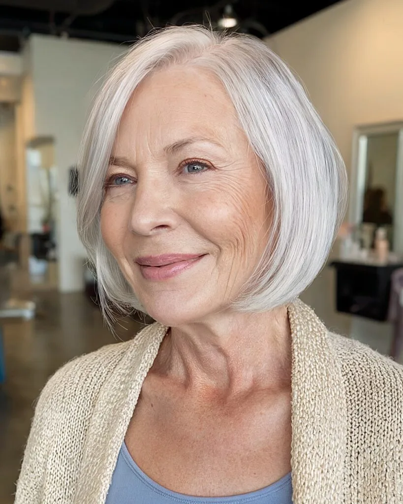 Short rounded bob with smooth finish for women over 70 with fine silver hair