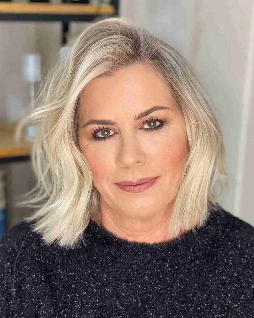 Stylish Short to Medium Haircut with a Deep Side Part for Women Over Fifty